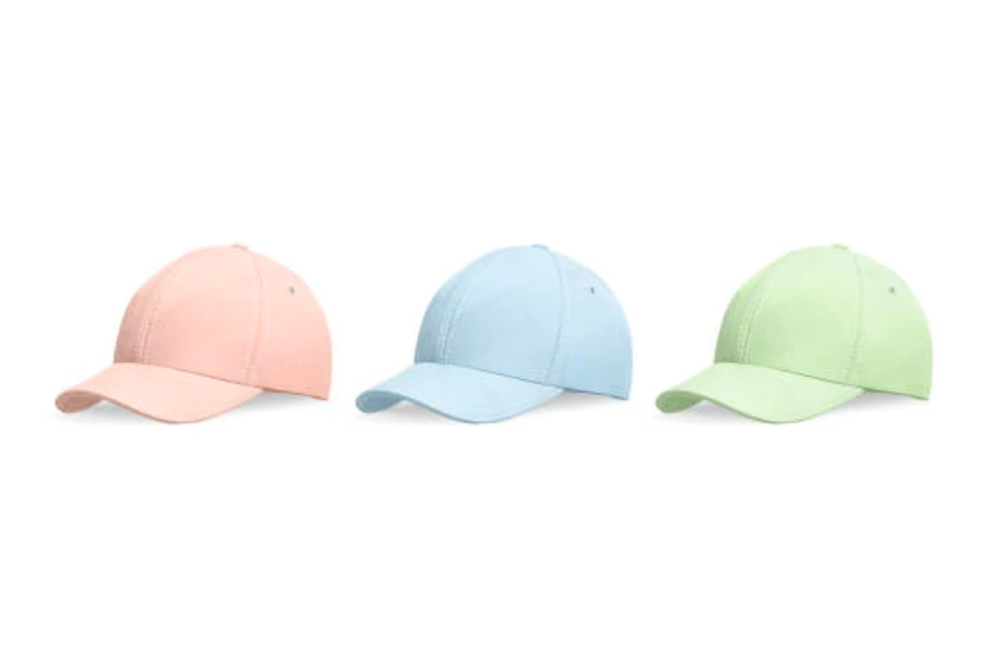 Tre cappellini da baseball nei colori rosa, blu e verde