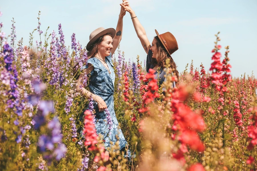 Two women dancing in a field of flowers