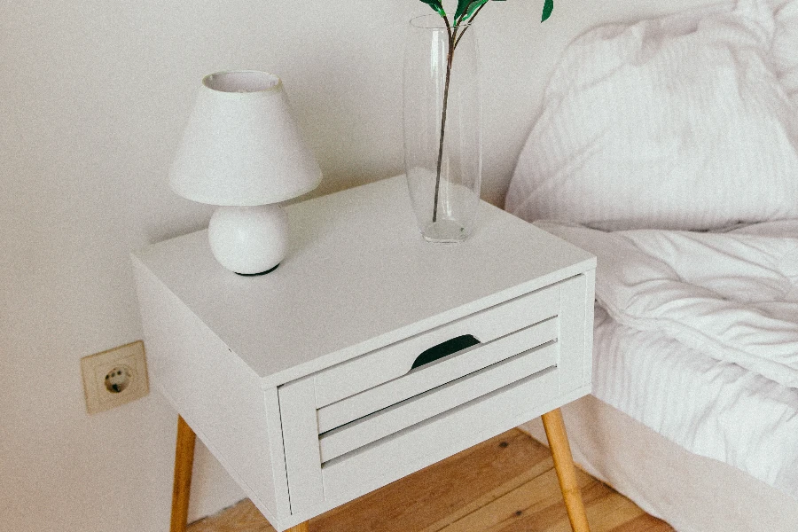 White table lamp on top of nightstand