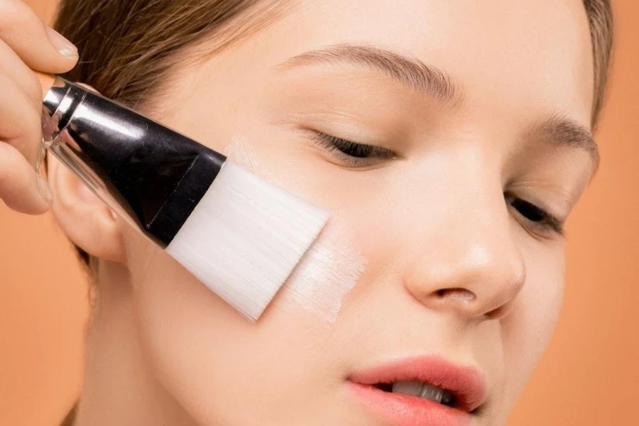 Woman applying matte finish with a makeup brush