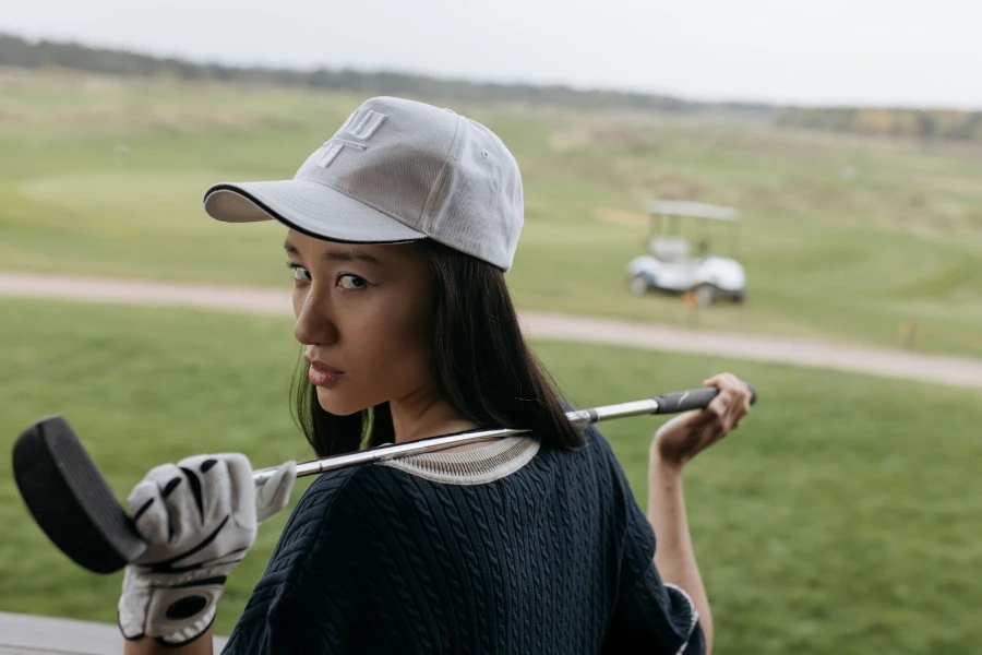 Woman golfing in a flex-fit baseball cap