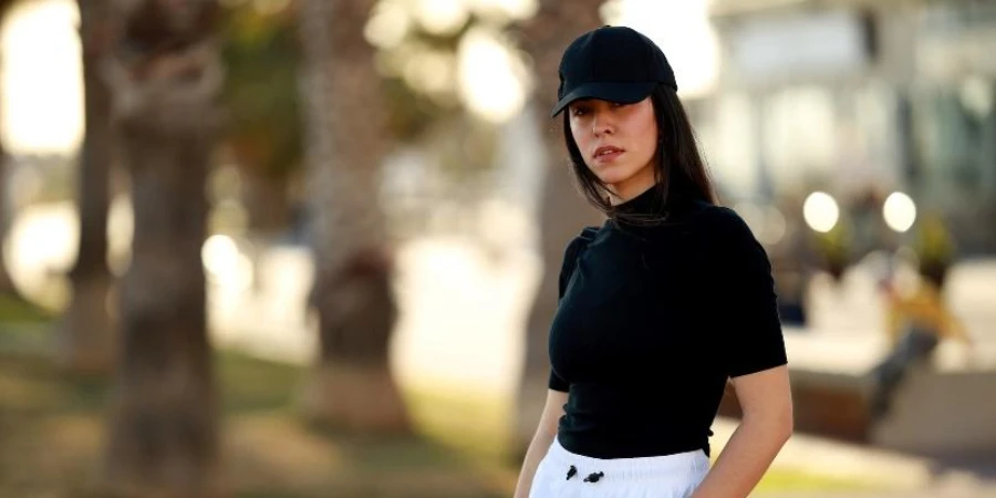 Woman outdoors wearing black sports cap