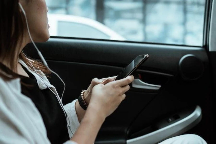 Woman using a mobile phone in a car