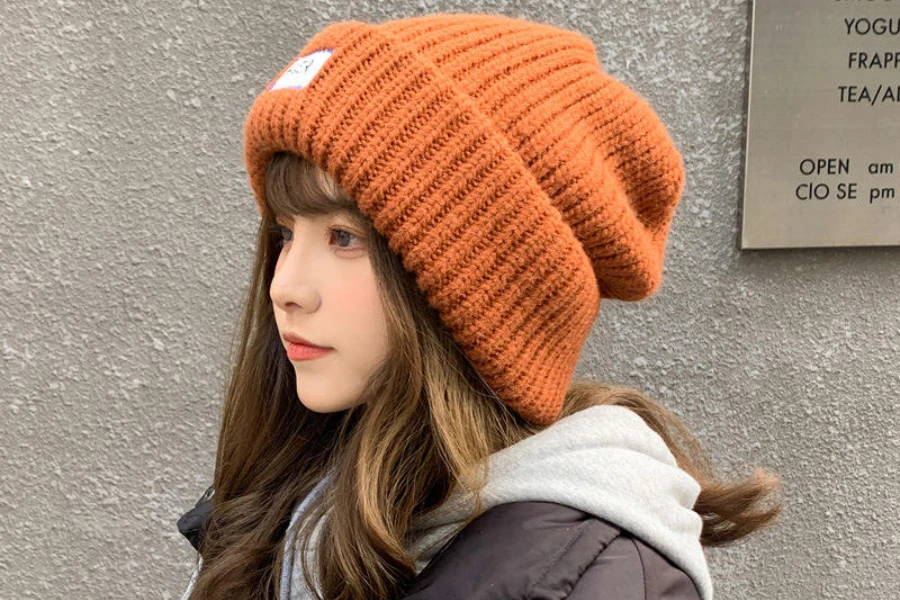 Woman wearing an orange slouchy beanie