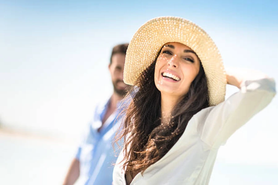 Woman wearing floppy Panama hat on the beach