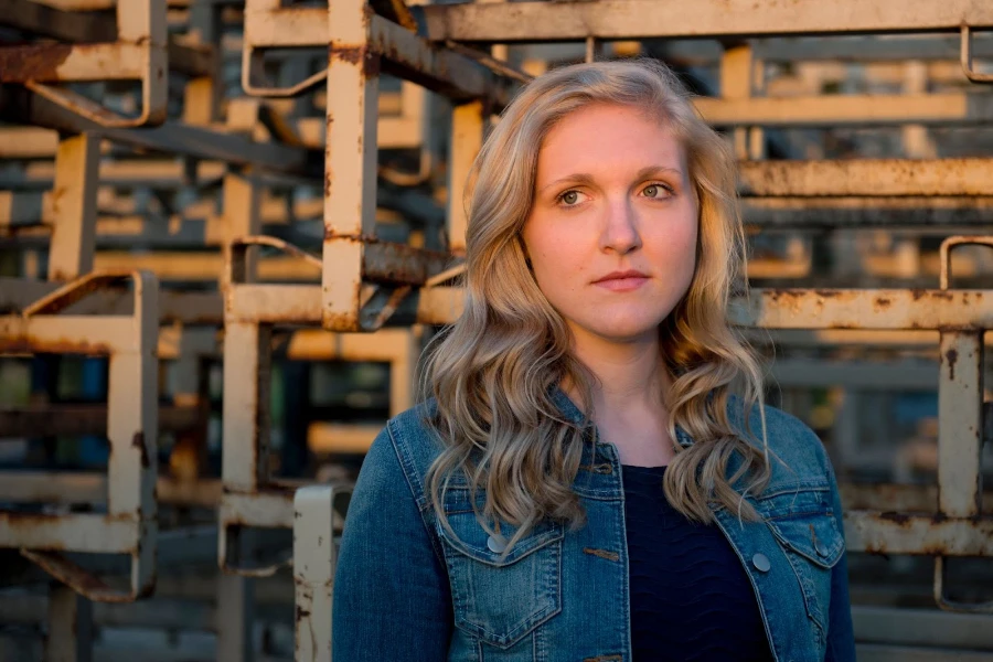 Young, blonde woman in an industrial area