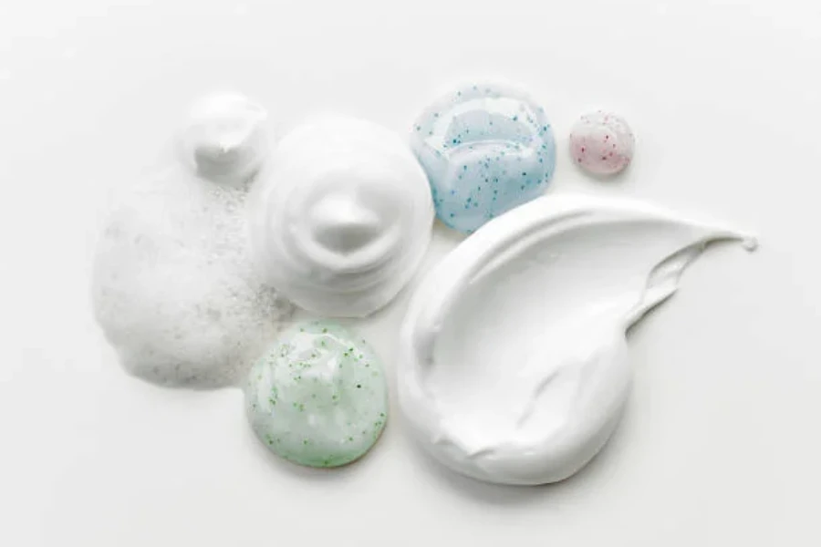 7 different types of creams, cleansers and foams in piles on a flat surface
