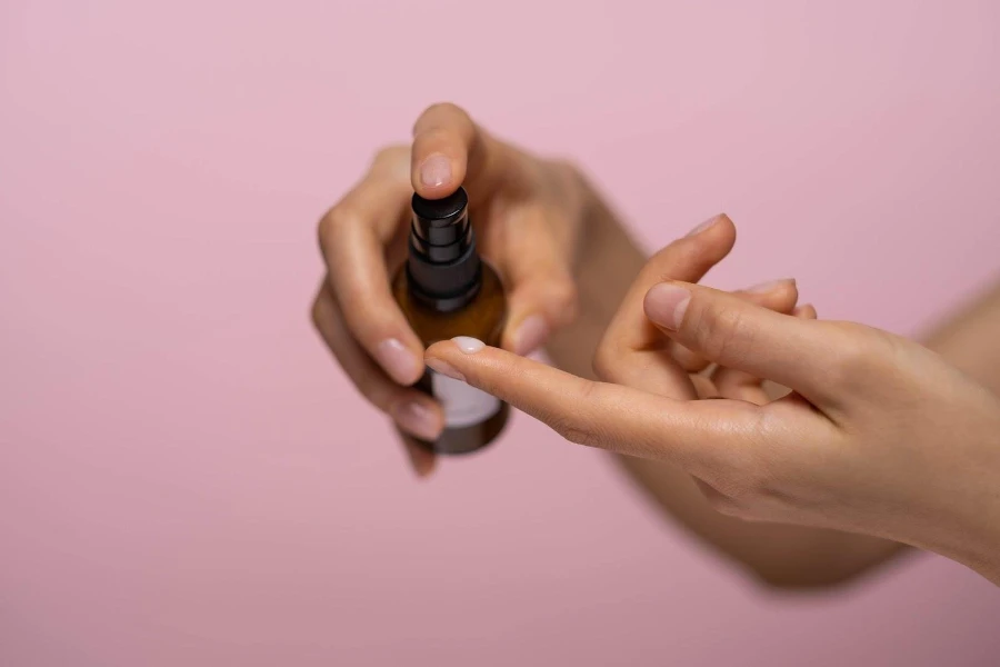A lady applying face serum on her fingertip