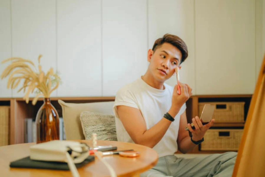 A man applying skincare using a beauty brush