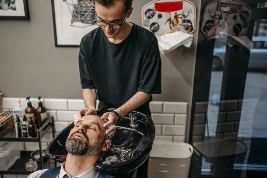 A man at a salon having his hair washed