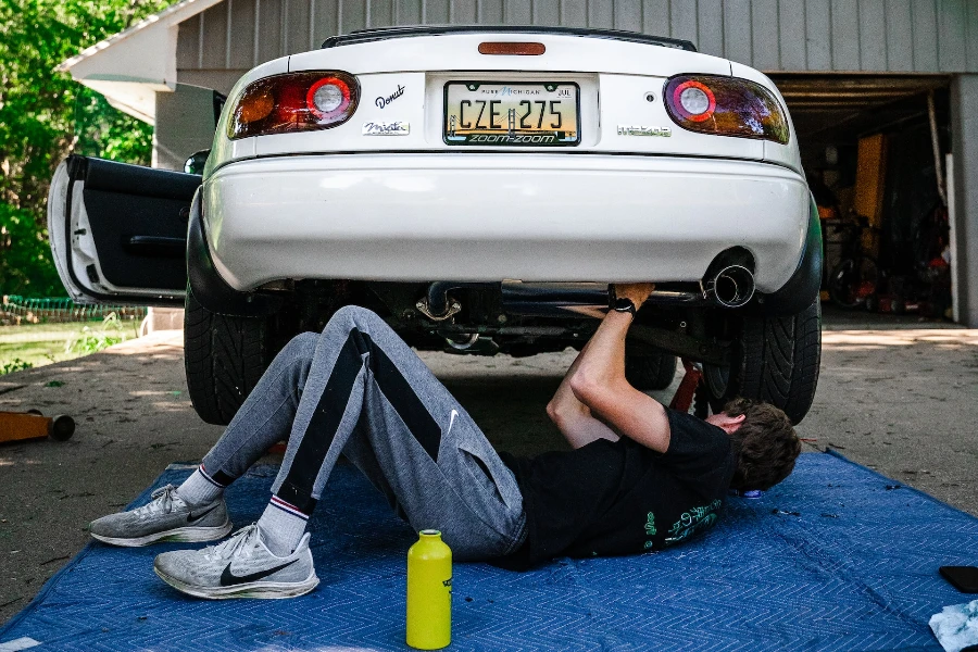 A man doing his own car part replacements