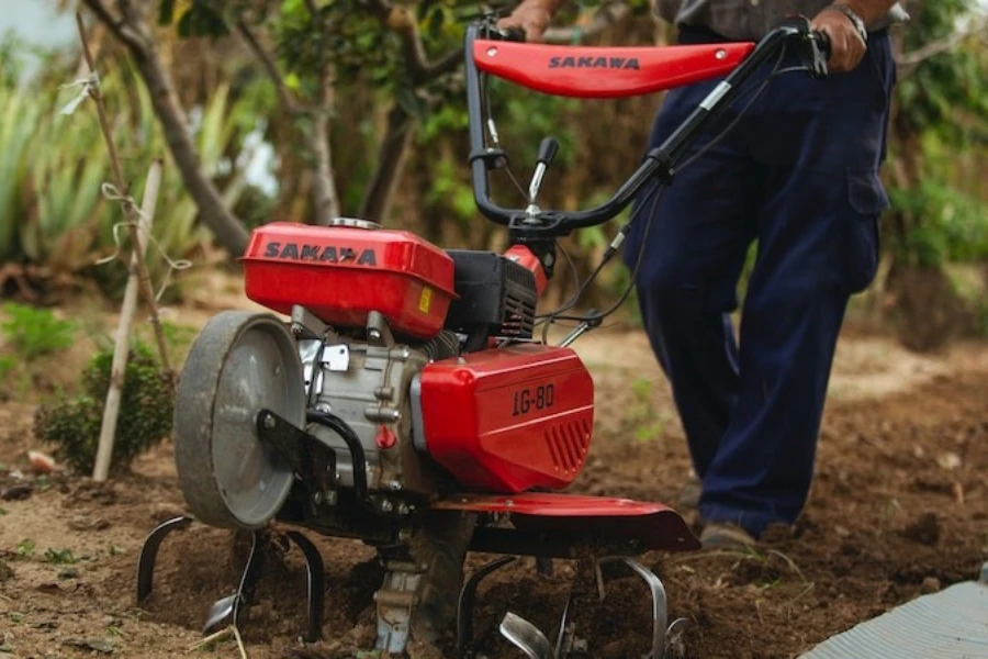 A man plowing the soil with a cultivator