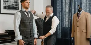 A tailor taking a man’s body measurement