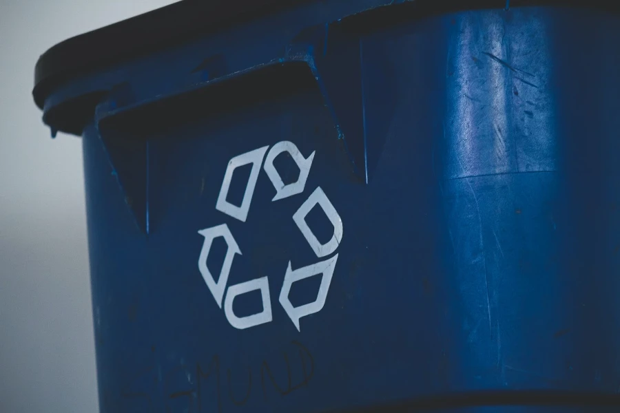 A waste bin with a recycling sign