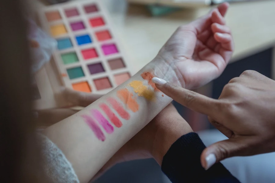 A woman's arm showcasing the different colors in an eye shallow pallet