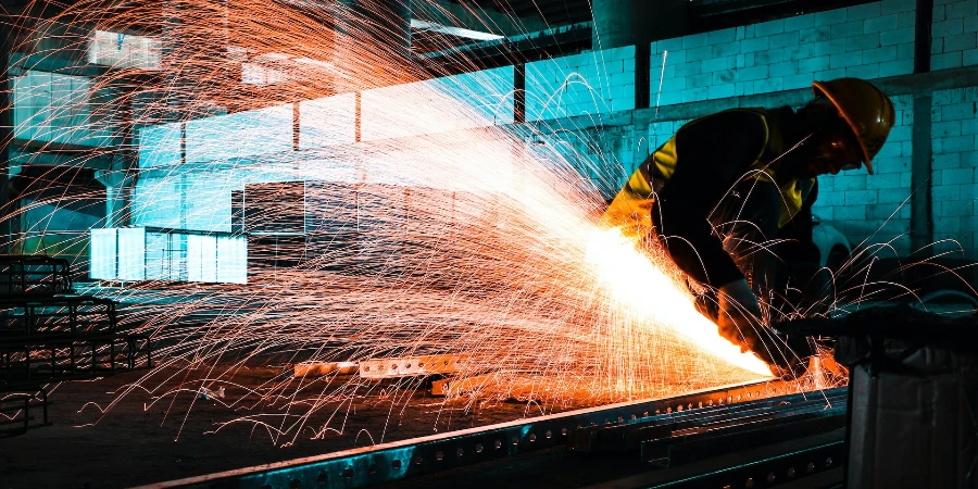A worker cutting metal