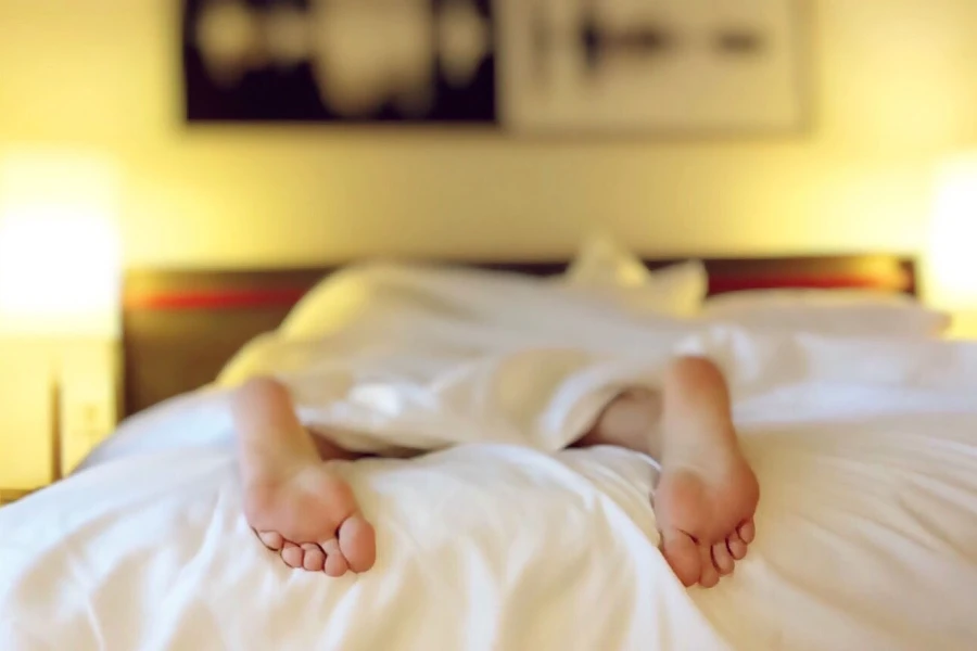 bare feet showing at bottom of bed