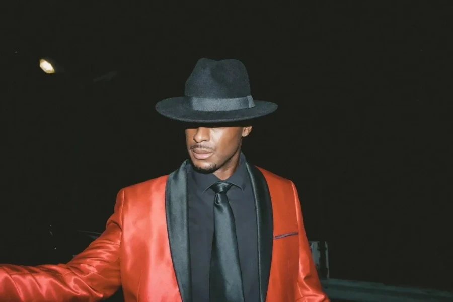 Man wearing a bright colored jacket and a black hat