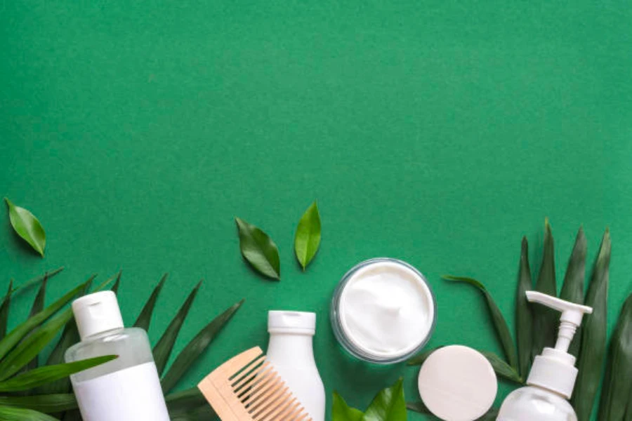 Natural beauty products on a green background with plants
