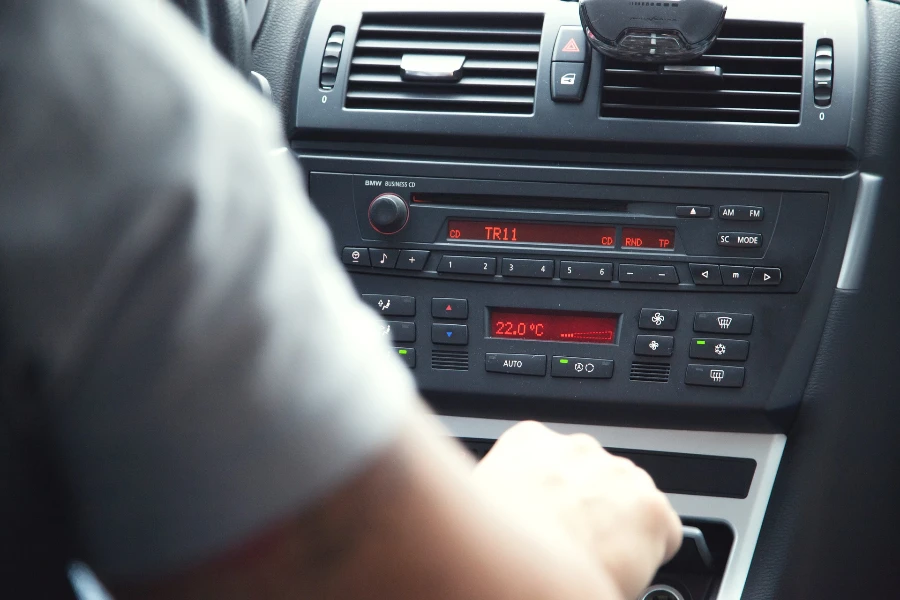 Person driving in a car with digital radio illuminated