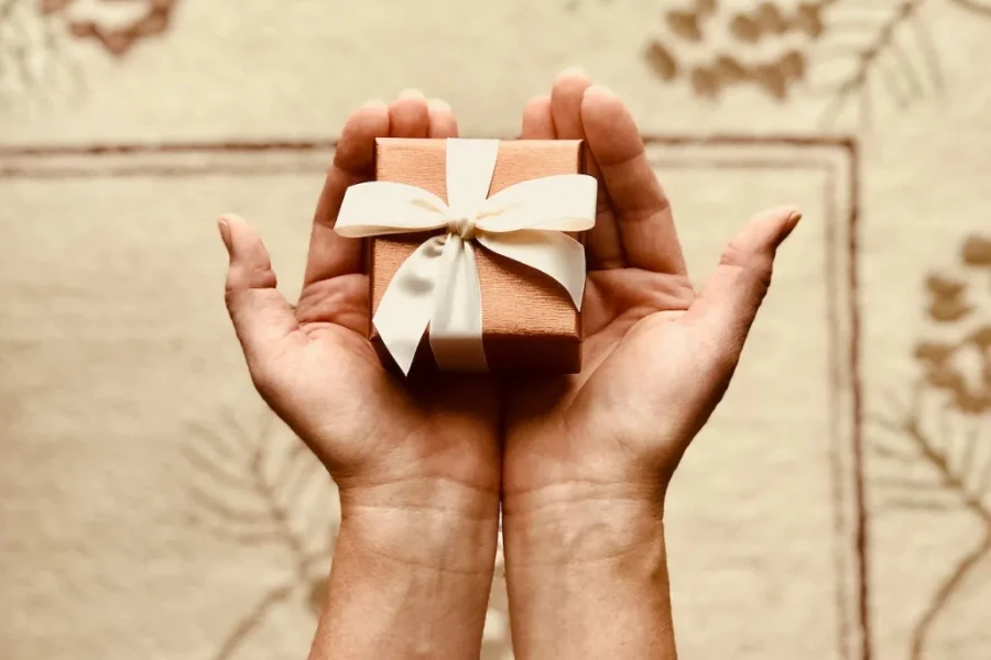 Person holding a brown gift box