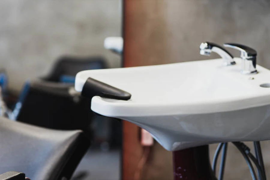 Shampoo chair and white sink with headrest built in