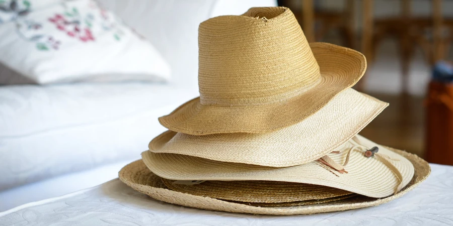 Straw hats stacked together on a table