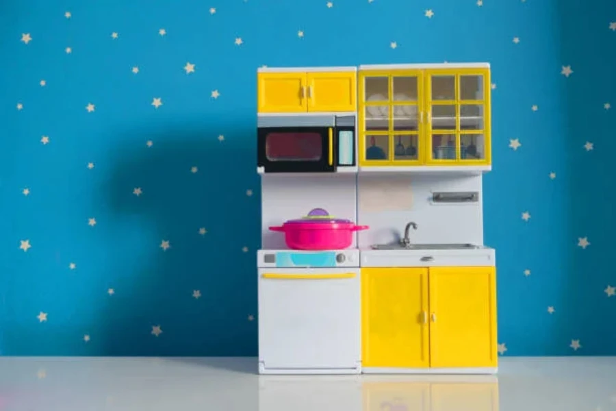 White and yellow toy kitchen against blue starry wallpaper