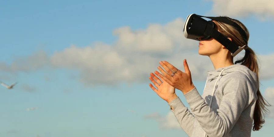Woman using VR goggles outdoors