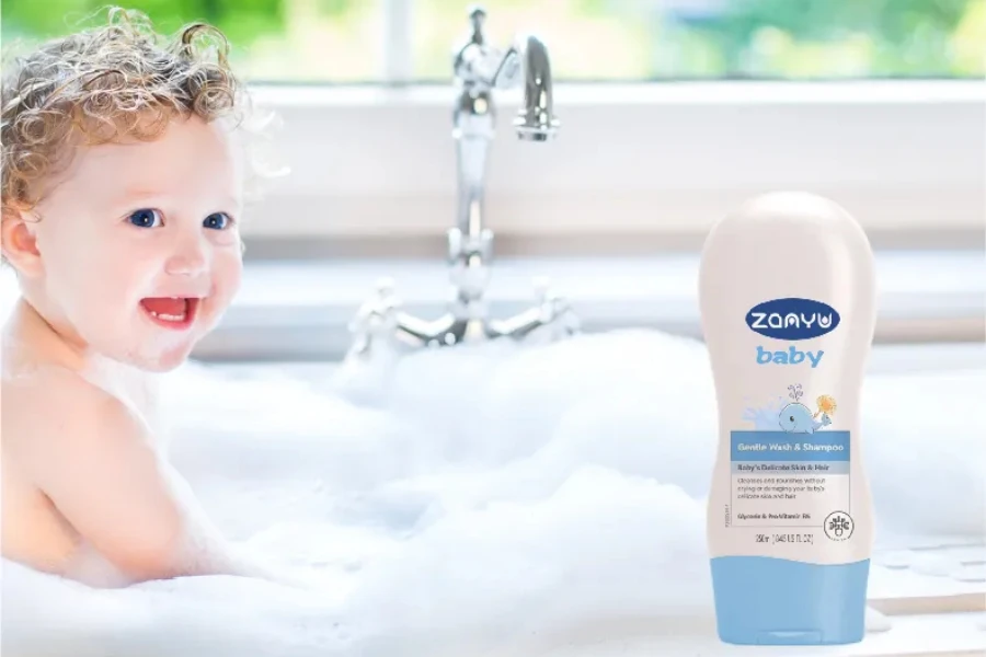 A baby in a bubble bath next to a shower gel