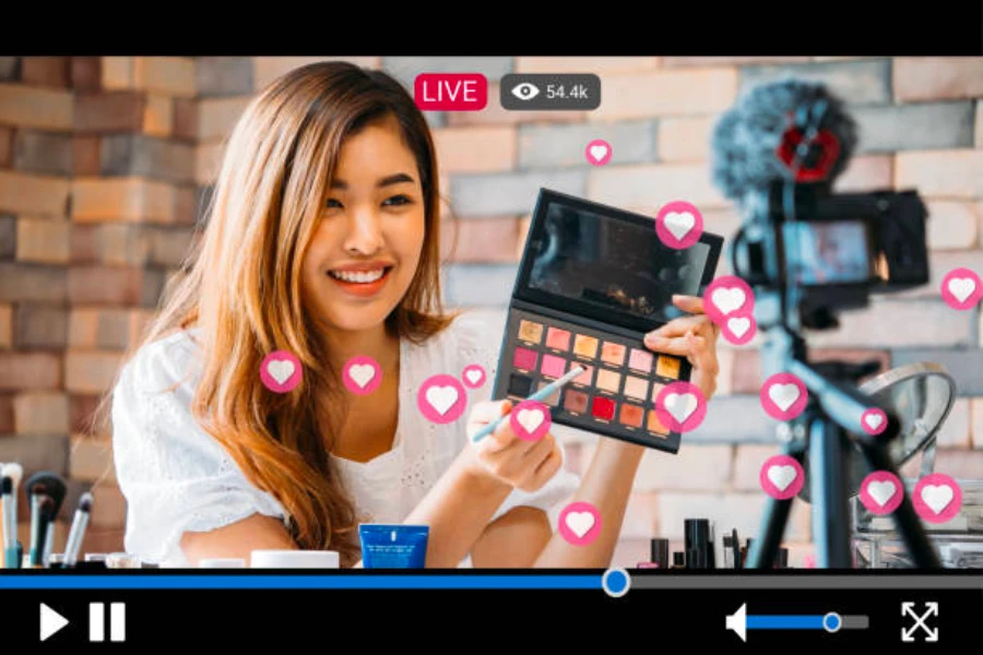 A beauty influencer recording herself applying eye shadow