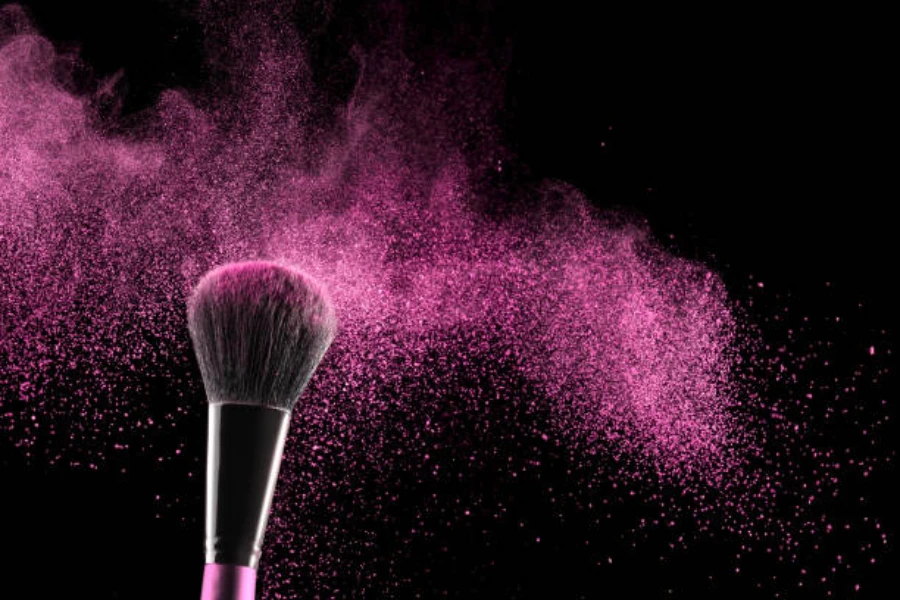 A black and pink buffing brush against a black background