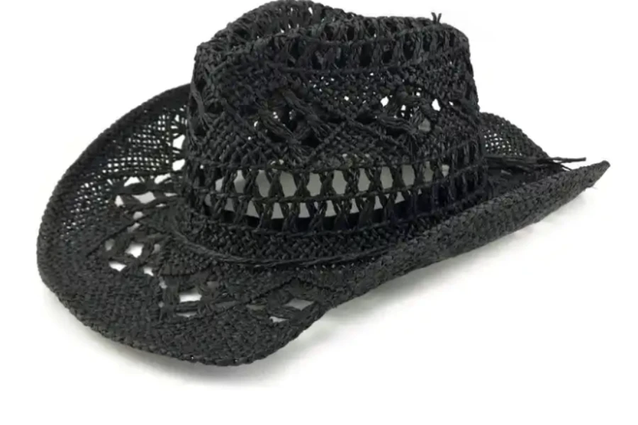 A black crochet cowboy hat on a white background