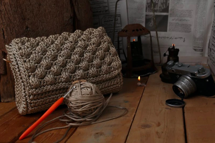 A dark grey crochet bag sitting on a table