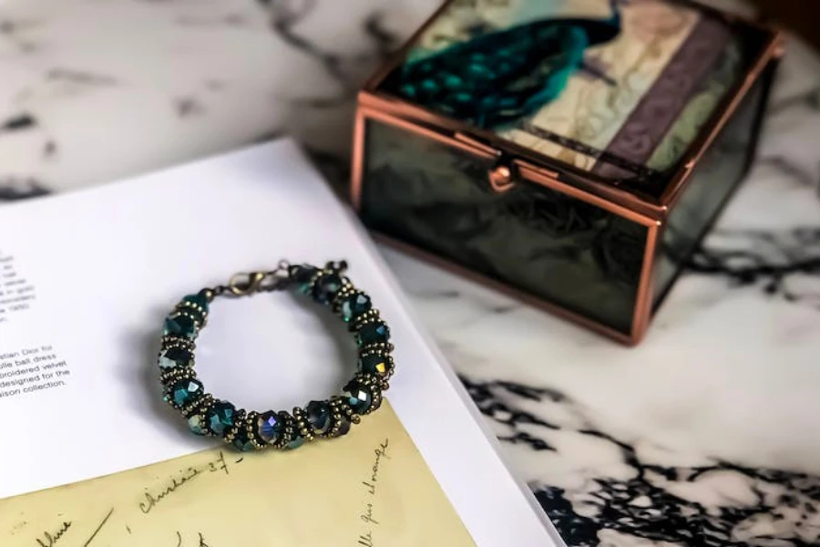 A marble table with a jewelry box and a bracelet