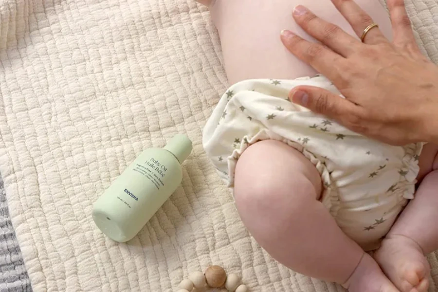 A mom massaging her baby with coconut oil