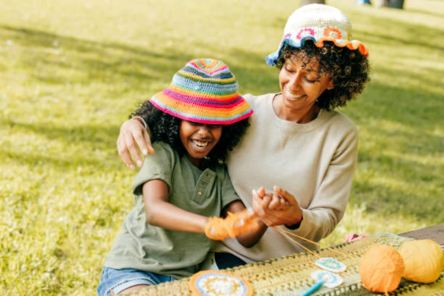 A mother and son wearing crochet bucket hats