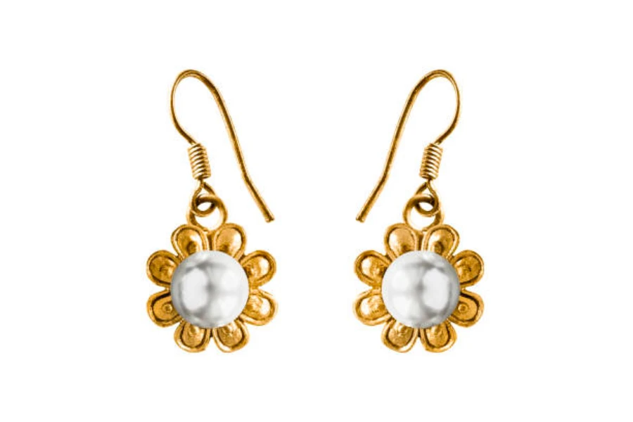 A pair of white and gold dangly earrings