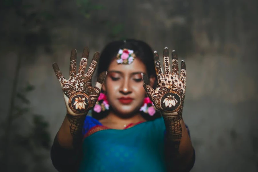 A woman in traditional Indian clothing with makeup and henna