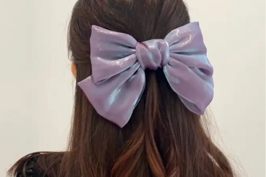 A woman wearing a big purple bow in her hair
