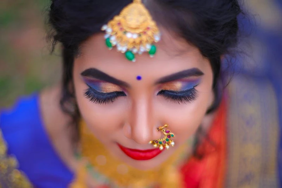 An Indian woman in traditional clothing wearing multicolored eyeshadow