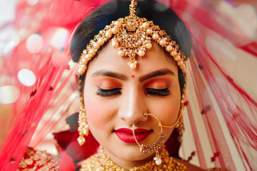 An Indian woman wearing traditional clothes and makeup