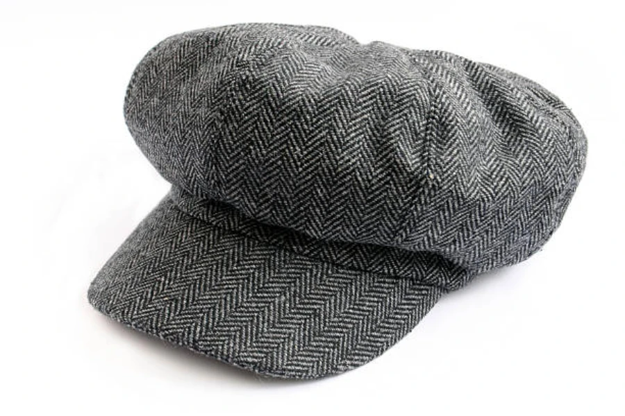 Black and gray newsboy hat on a white background