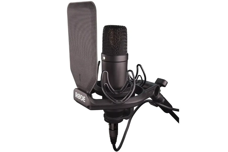 Black microphone on a stand with a pop shield