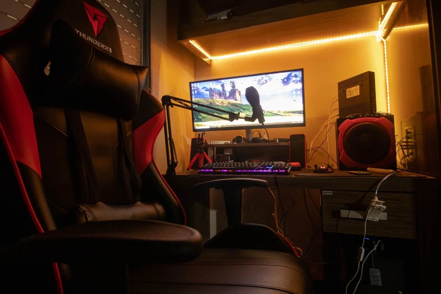 Desk with computer monitor, microphone and a lot of cords