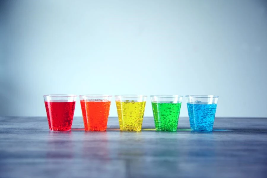 Five plastic cups with colorful liquid
