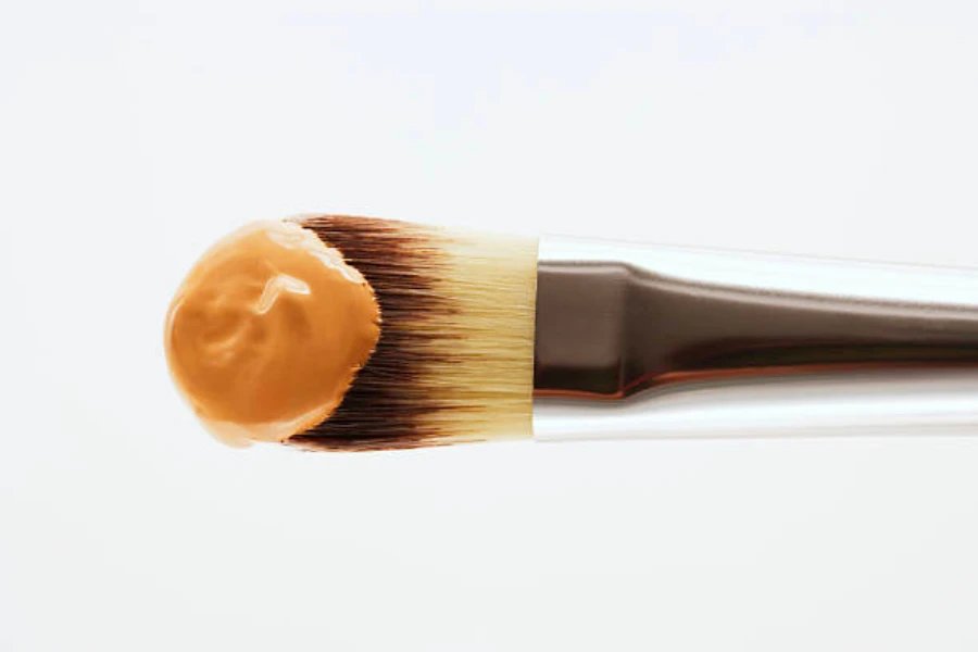 Flat brush with firm bristles and concealer