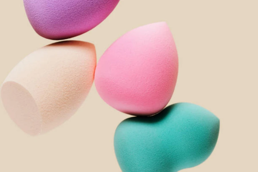 Four beauty blenders stacked on top of one another