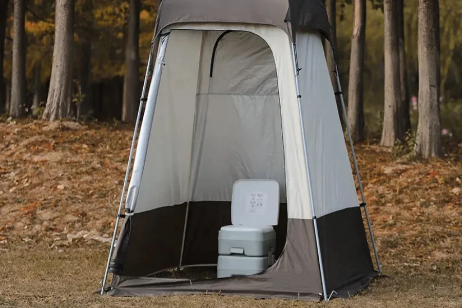 Grey and black tall privacy shelter with portable toilet