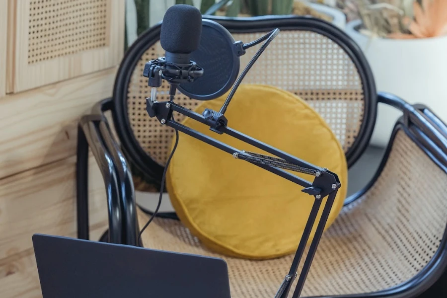 Laptop and microphone set up in front of an empty chair